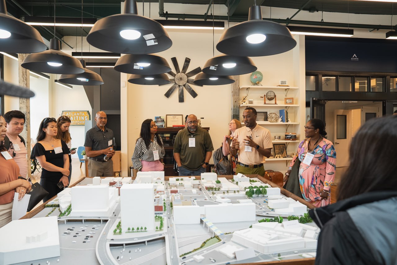 Jamal Lewis of PIN engaging community members around a project model during a leaders program